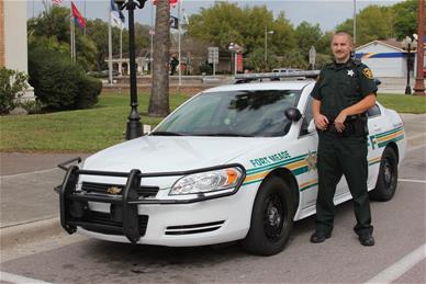 Fort Meade Deputy in front of patrol car