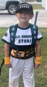 Child wearing a Polk Sheriff's Charities sports uniform